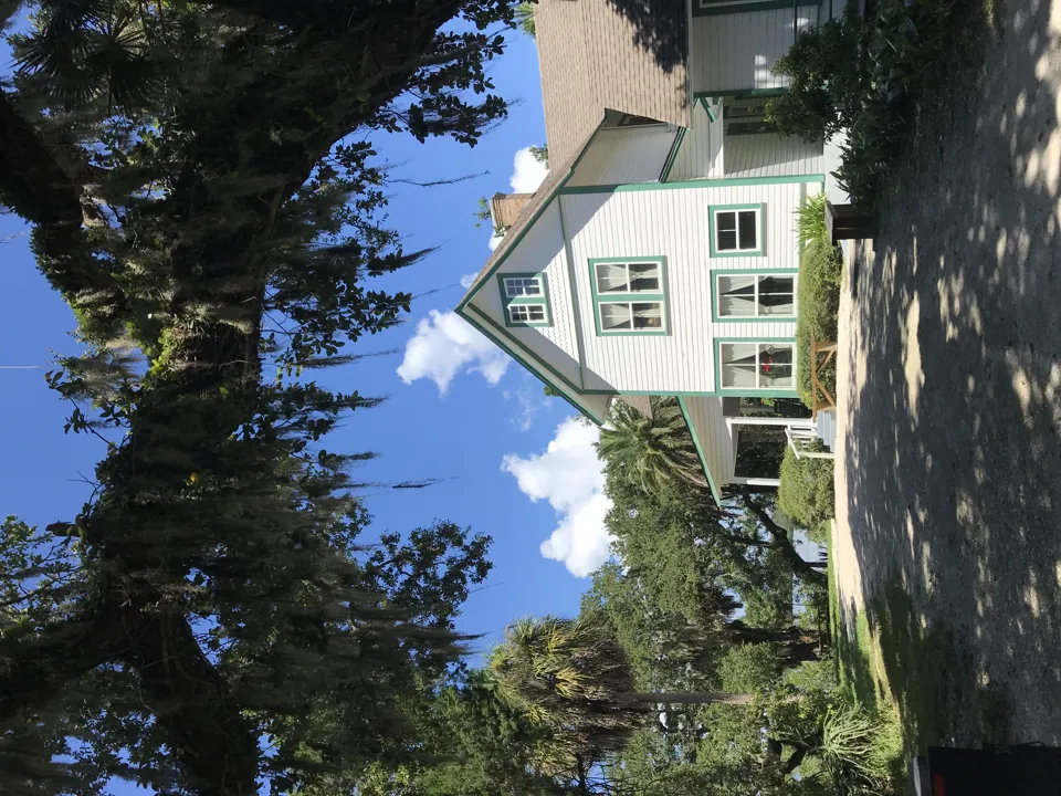 Historic house shaded by moss-draped oaks at Historic Spanish Point, Osprey, Florida, 2018.