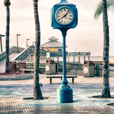Fort Myers Beach clock and palm-lined pier entrance, Florida