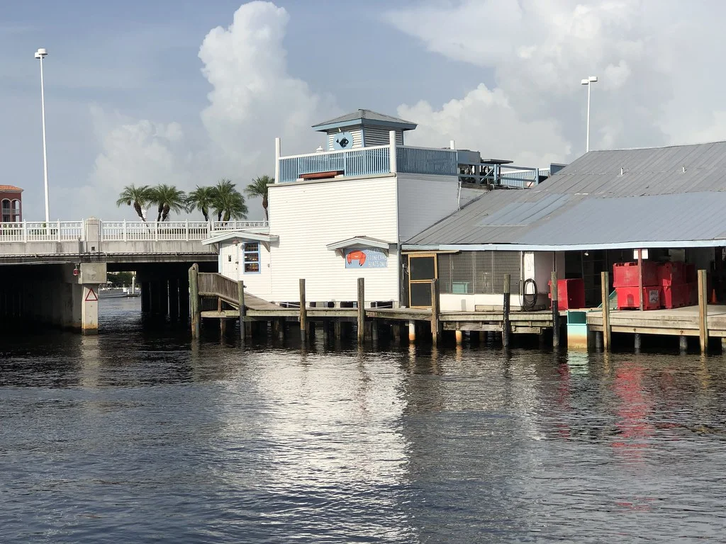 Tin City waterfront buildings and docks beside the river in Naples