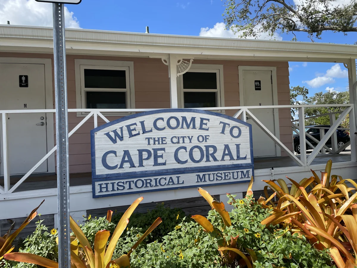 Cape Coral Historical Museum sign in front of its porch and garden
